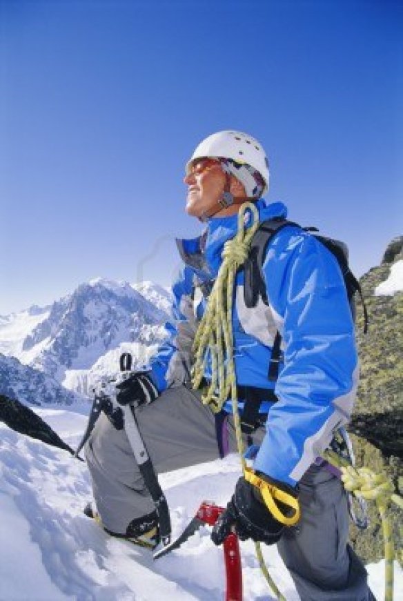 3196261-mountain-climber-coming-up-snowy-mountain-smiling